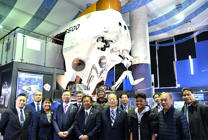 roup photo in front of the model of our manned submersible